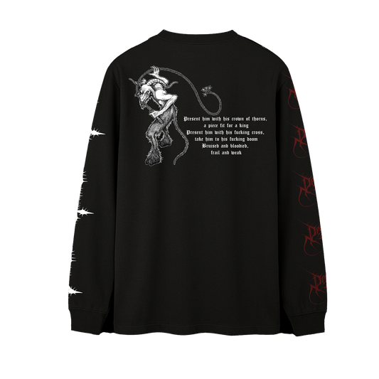 A black long-sleeve t-shirt shown from the back, featuring a white graphic of a horned devil figure with a whip and a block of gothic text. The right sleeve has white barbed wire graphics, and the left sleeve has red gothic script graphics.